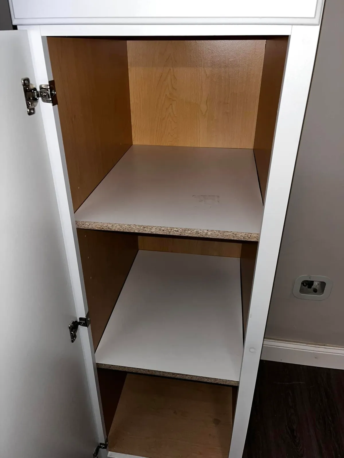 Finished white built-in cabinets installed along an interior wall