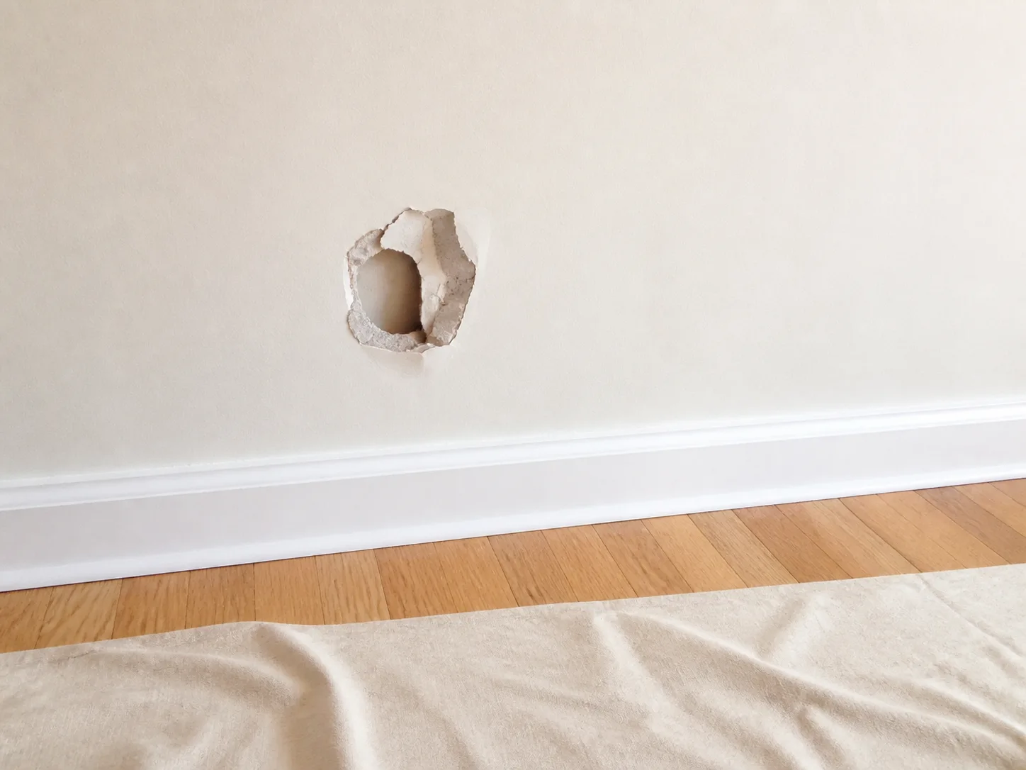 Damaged drywall before repair